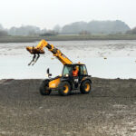 JCB on shore Chichester Harbour Sussex