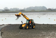 JCB on shore Chichester Harbour Sussex