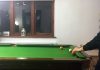 Playing pool at pool table indoors