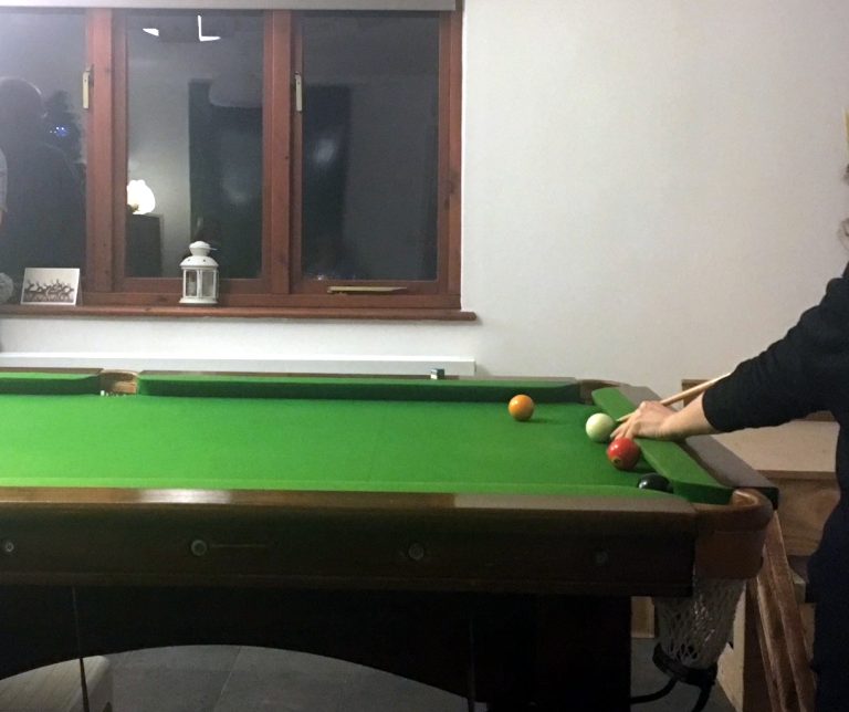 Playing pool at pool table indoors
