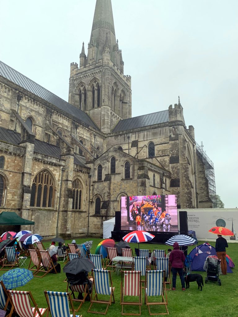 Coronation Charles III procession with horses, on big screen outside Chichester cathedral, West Sussex