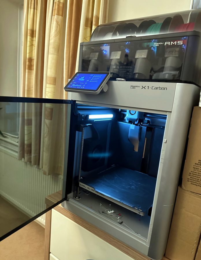 Bambu Lab X1-Carbon Combo 3D Printer with open door and colour filament. Photo by A. Howse