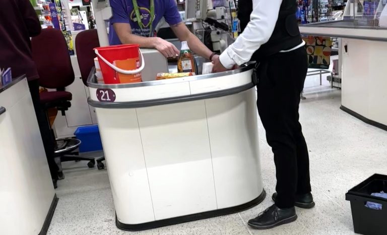 Supermarket manager and security team member asses stolen groceries recovered from known shoplifter, Hampshire
